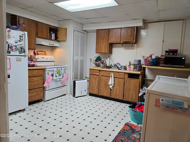 a kitchen with stainless steel appliances a stove a sink and a refrigerator