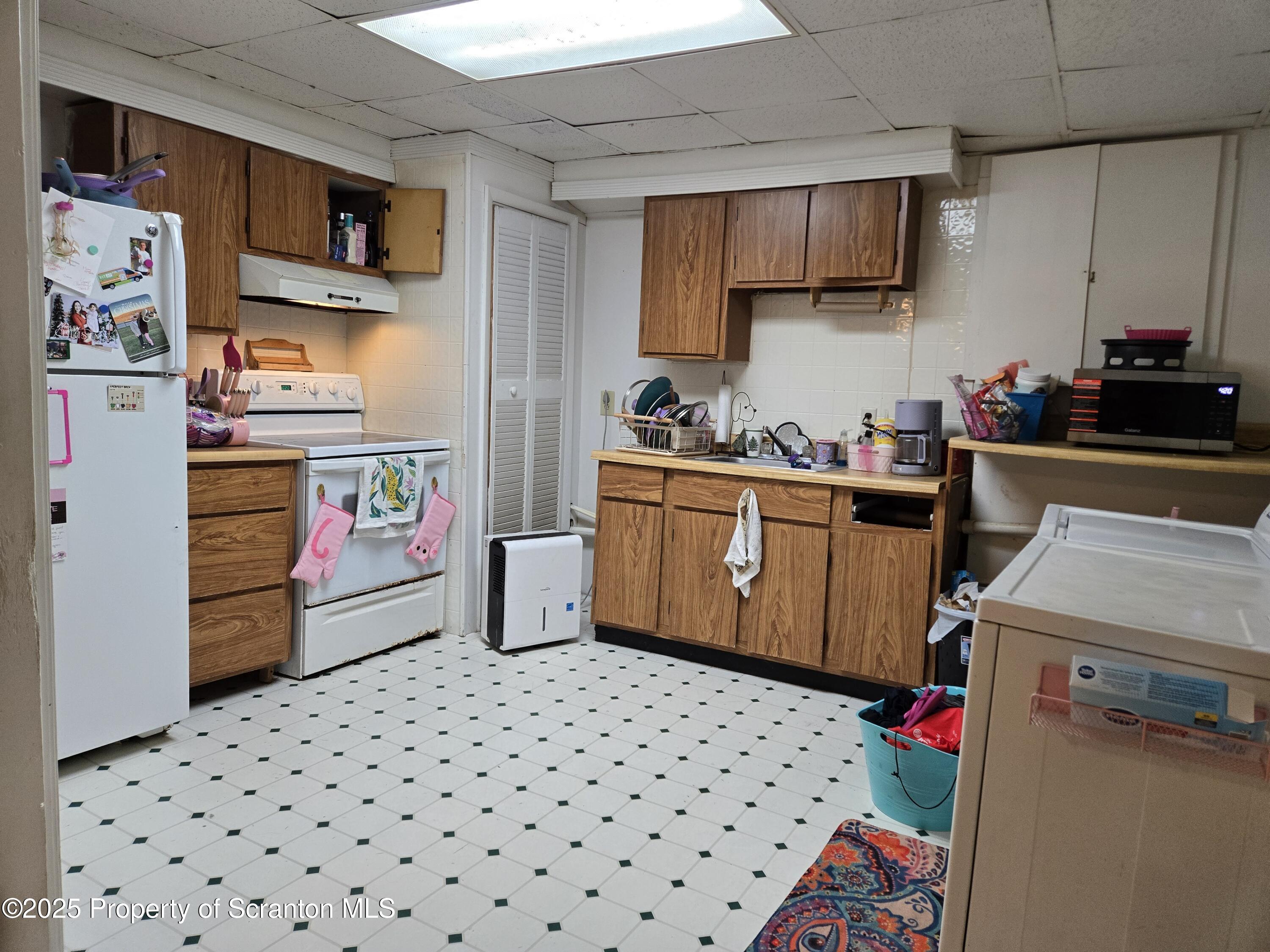 1228 Lake Road Factoryville, PA 18419 - Photo 27 of 31 a kitchen with stainless steel appliances a stove a sink and a refrigerator