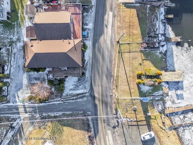 a view of swimming pool with outdoor seating and a garden