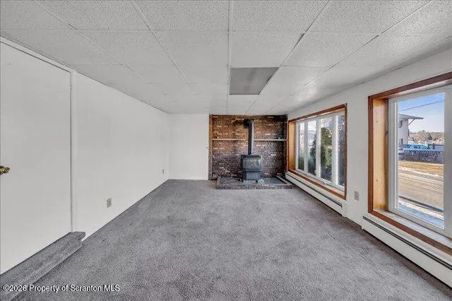 a view of an empty room with a fireplace