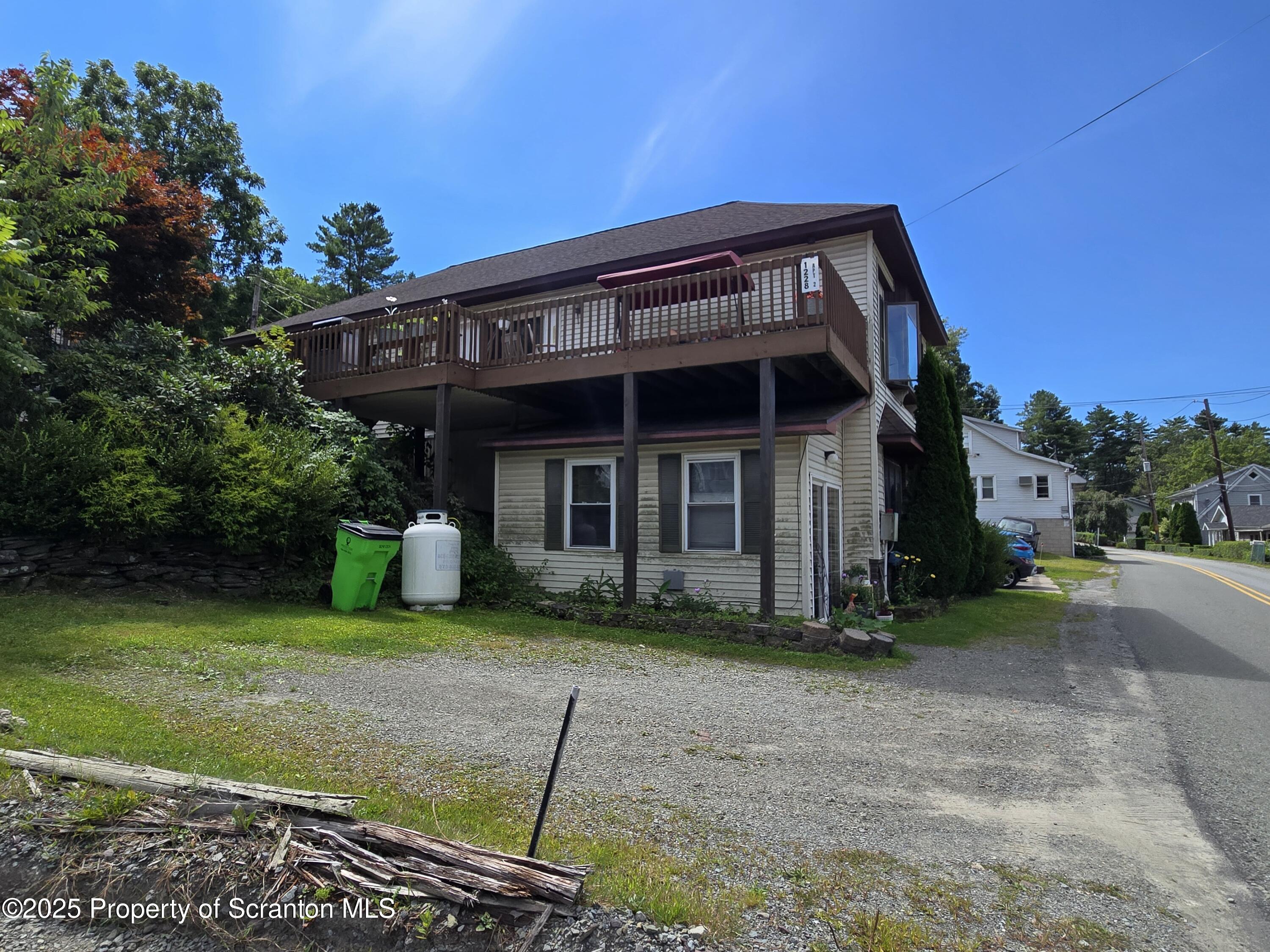 1228 Lake Road Factoryville, PA 18419 - Photo 8 of 31 a view of a house with a yard plants and large tree