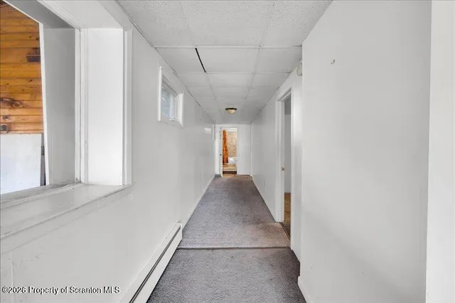 an empty room with windows & dryer