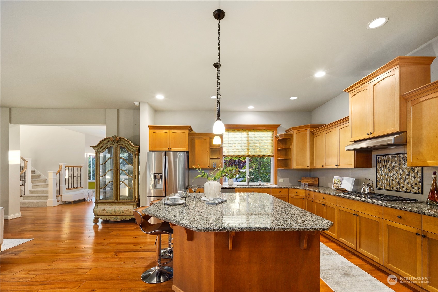 20278 86th Place Northeast Bothell, WA 98011 - Photo 8 of 34 a kitchen with stainless steel appliances granite countertop a sink counter space and living room view