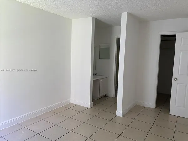 a view of an empty room and closet area