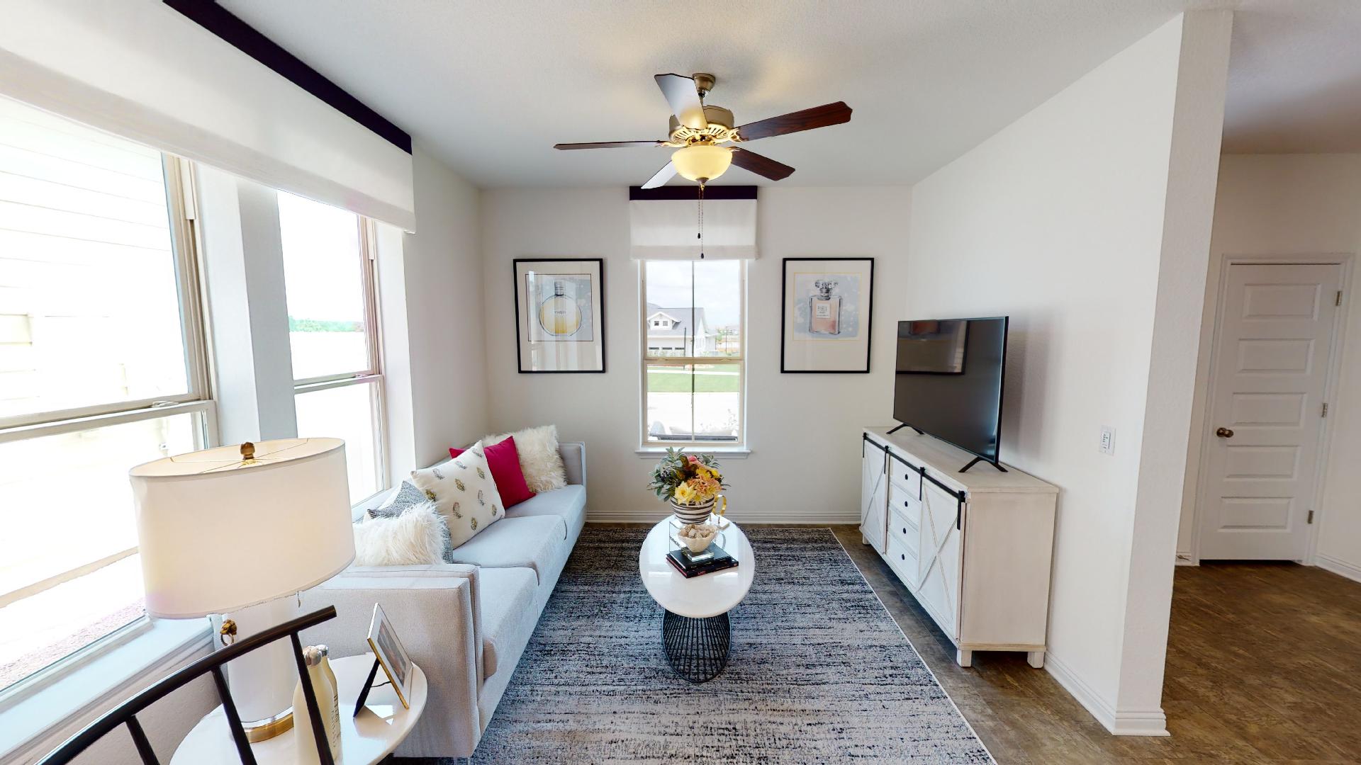 8105 Springsteen Drive Austin, TX 78744 - Photo 3 of 10 Living area with ceiling fan and dark wood-style floors