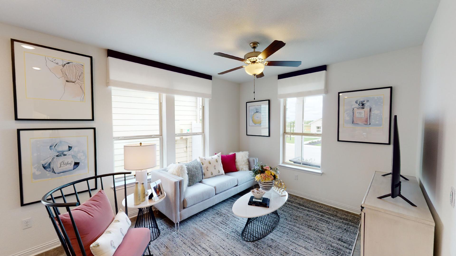 8105 Springsteen Drive Austin, TX 78744 - Photo 5 of 10 Living area with baseboards and a ceiling fan