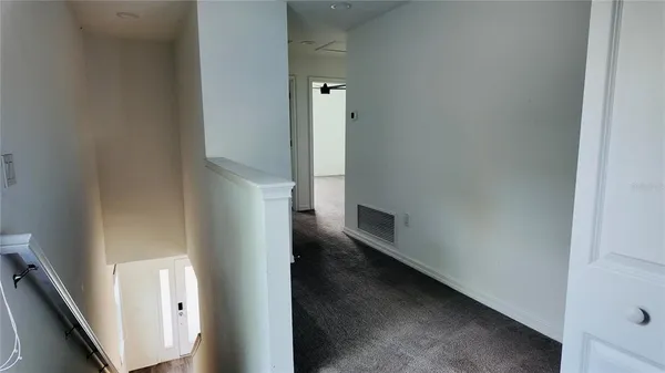 a view of a hallway view with staircase