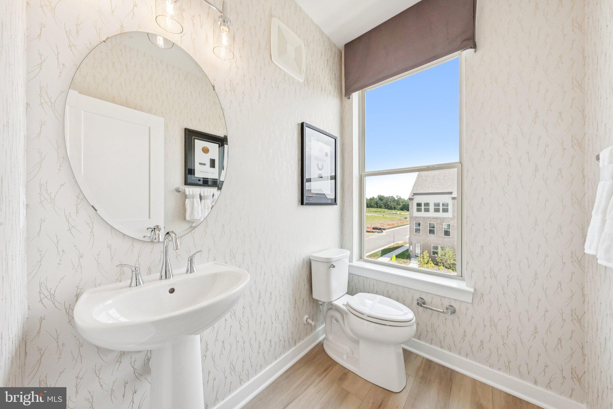 6709 Belcrest Road Hyattsville, MD 20782 - Photo 14 of 27 a bathroom with a toilet a sink and a mirror
