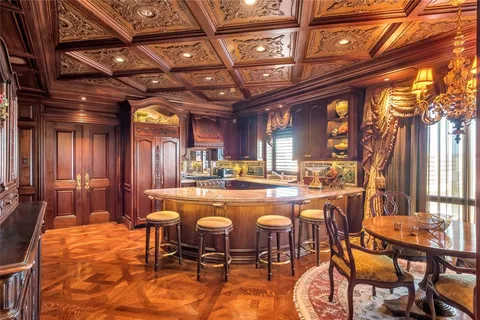 a living room with furniture a fireplace and a chandelier