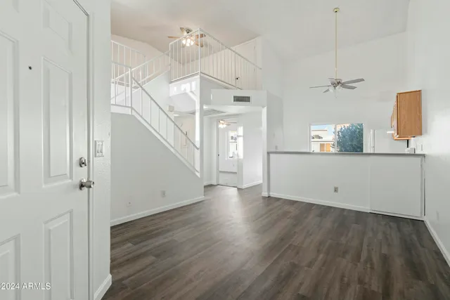 a view of a kitchen with wooden floor and a sink