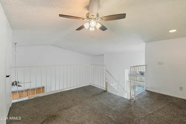 a view of an empty room with a ceiling fan