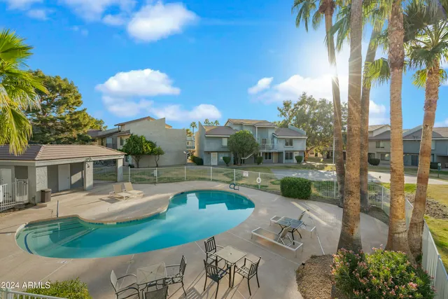 a view of a house with pool and a yard