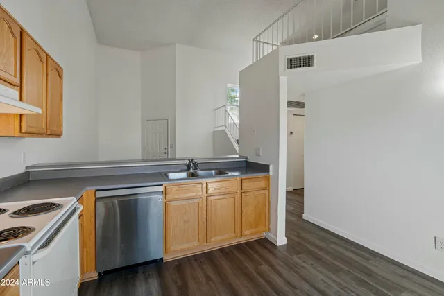 a view of a kitchen with sink and wooden floor
