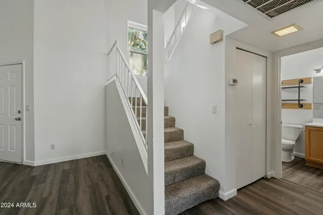 a view of entryway and hall with wooden floor