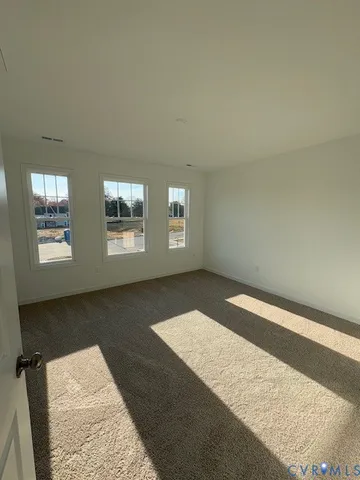 a view of an empty room with windows