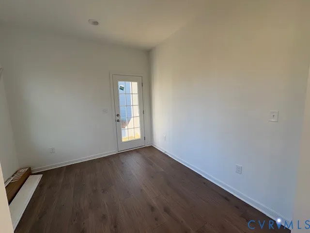 a view of an empty room and wooden floor