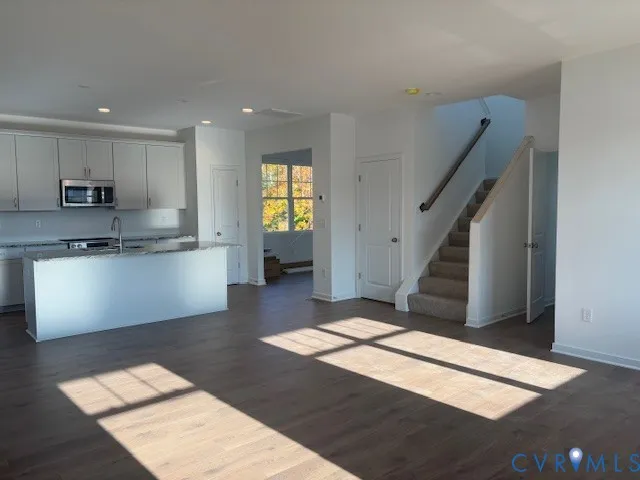a view of kitchen with sink microwave and stove