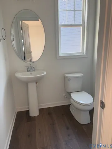 a white toilet sitting next to a bathroom sink