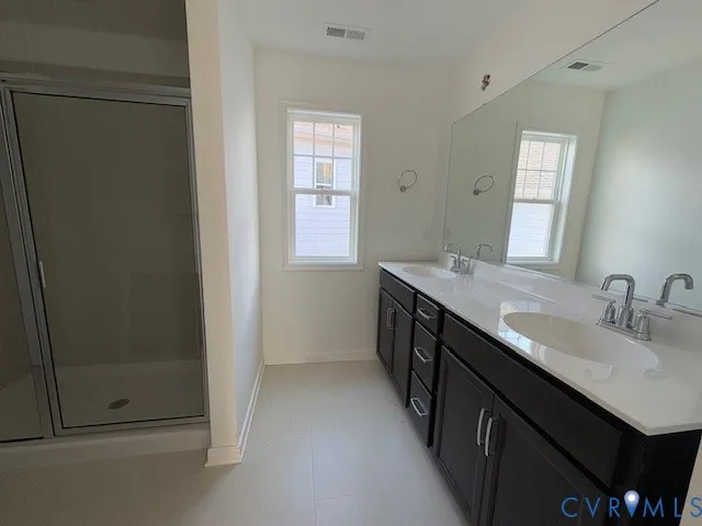 a bathroom with a double vanity sink a and mirror