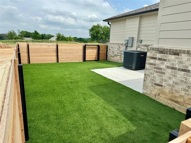 a view of a backyard with sitting area