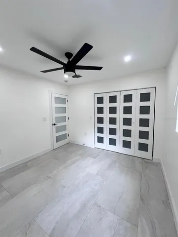 a view of an empty room with a ceiling fan