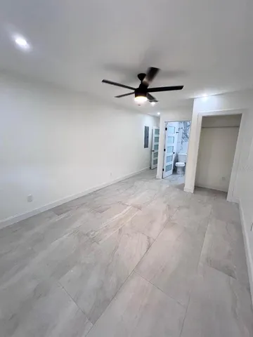 a view of a livingroom with a ceiling fan and window
