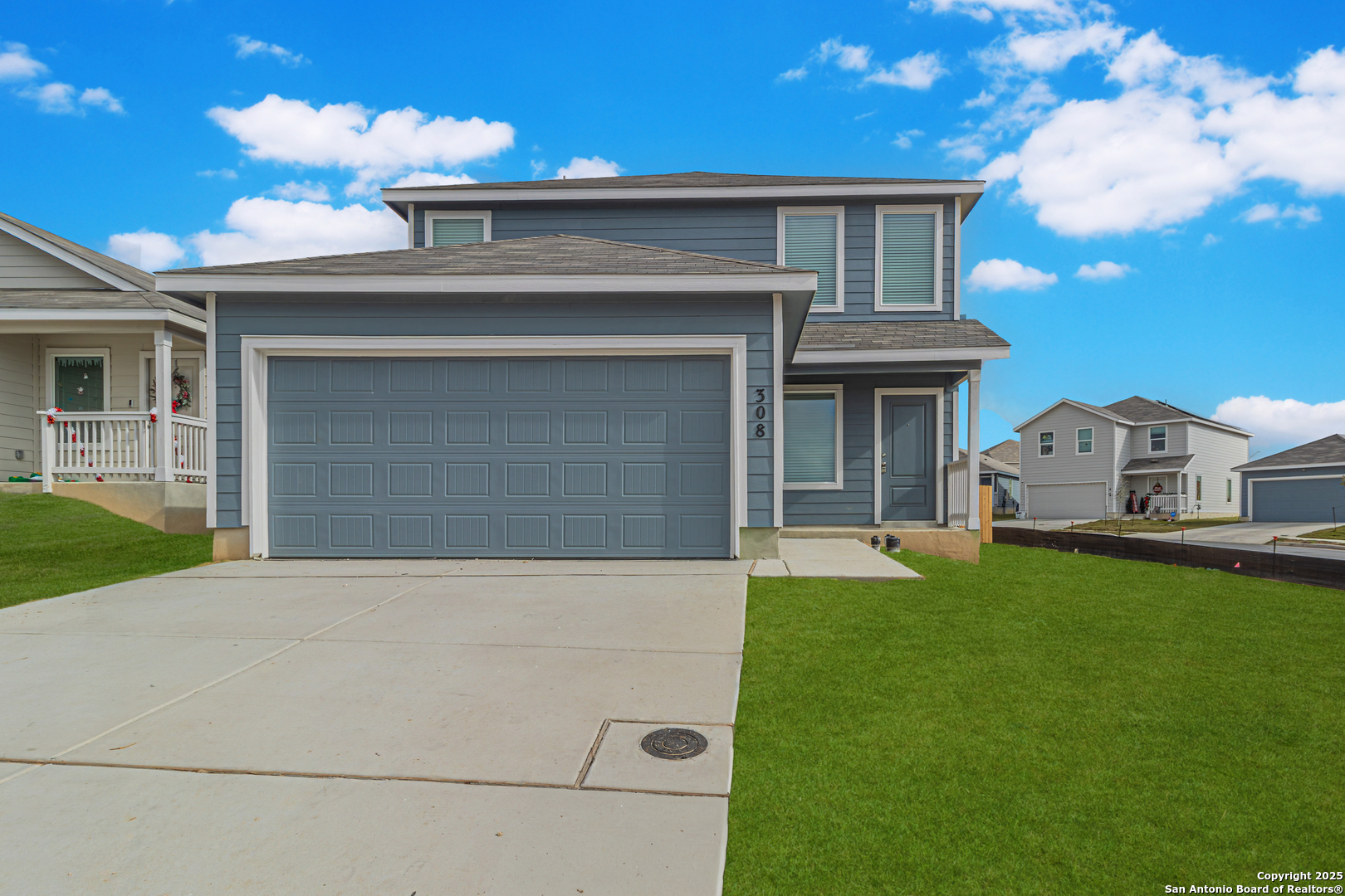 a front view of a house with a garden and yard