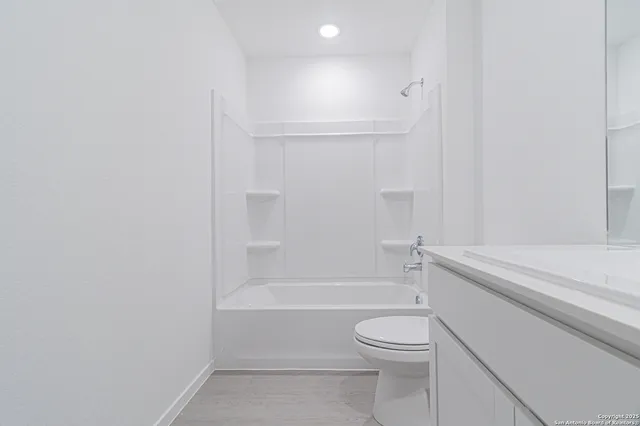 a bathroom with a toilet and a bath tub