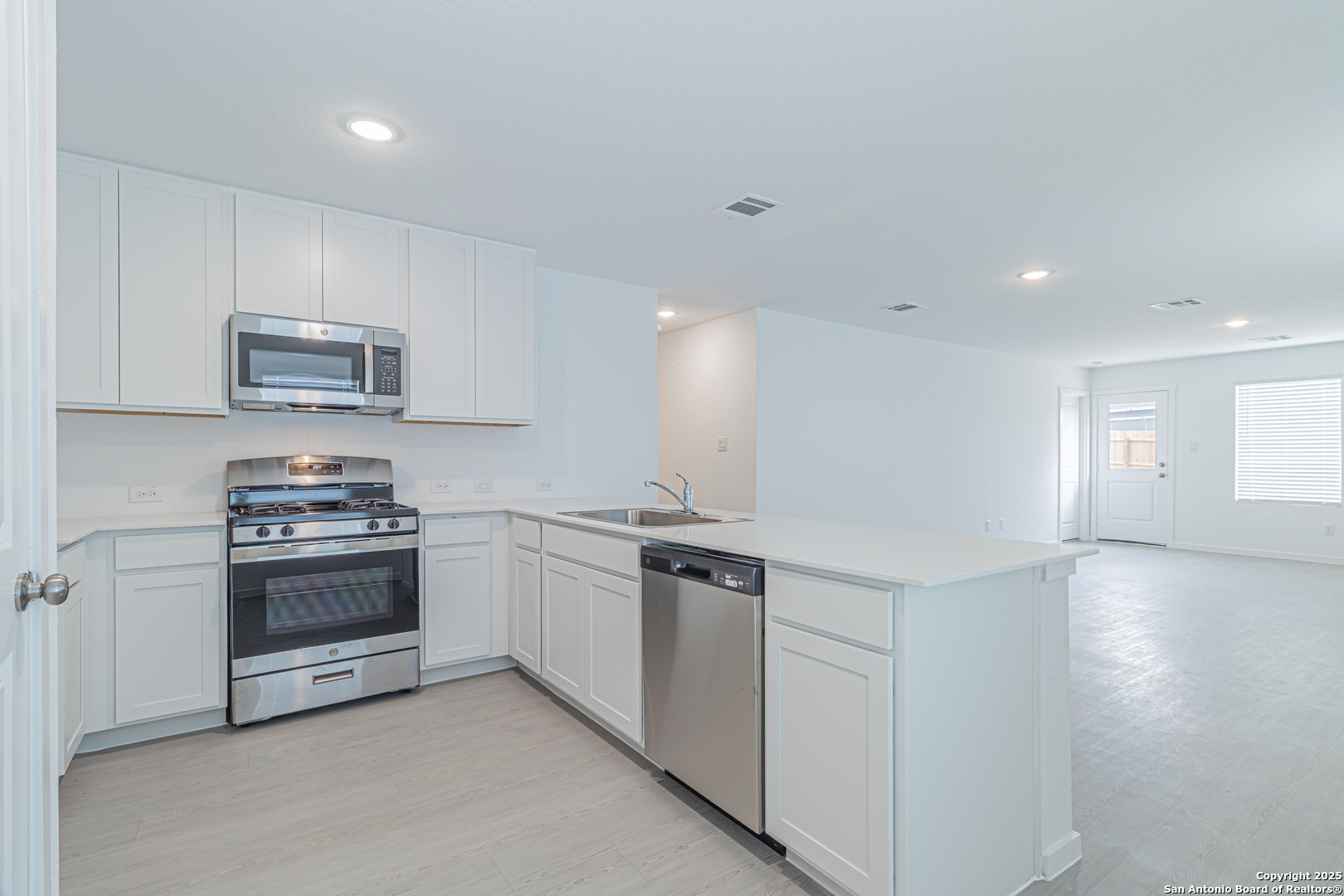 308 Kayden Court Marion, TX 78124 - Photo 4 of 23 a kitchen with stainless steel appliances granite countertop a stove and a sink