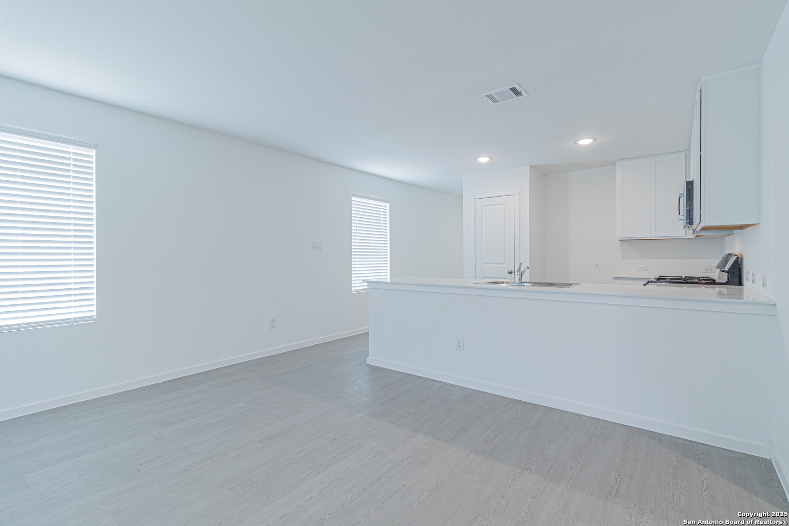 308 Kayden Court Marion, TX 78124 - Photo 6 of 23 a view of an empty room with kitchen view and window