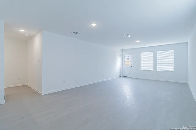 an empty room with windows and closet