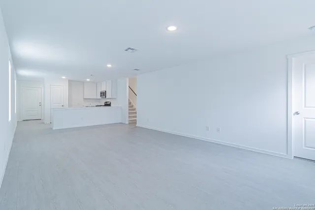 a view of a kitchen with a sink and a refrigerator