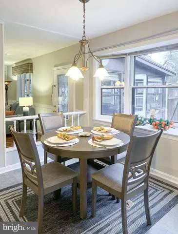 a room with a table chairs and a stove