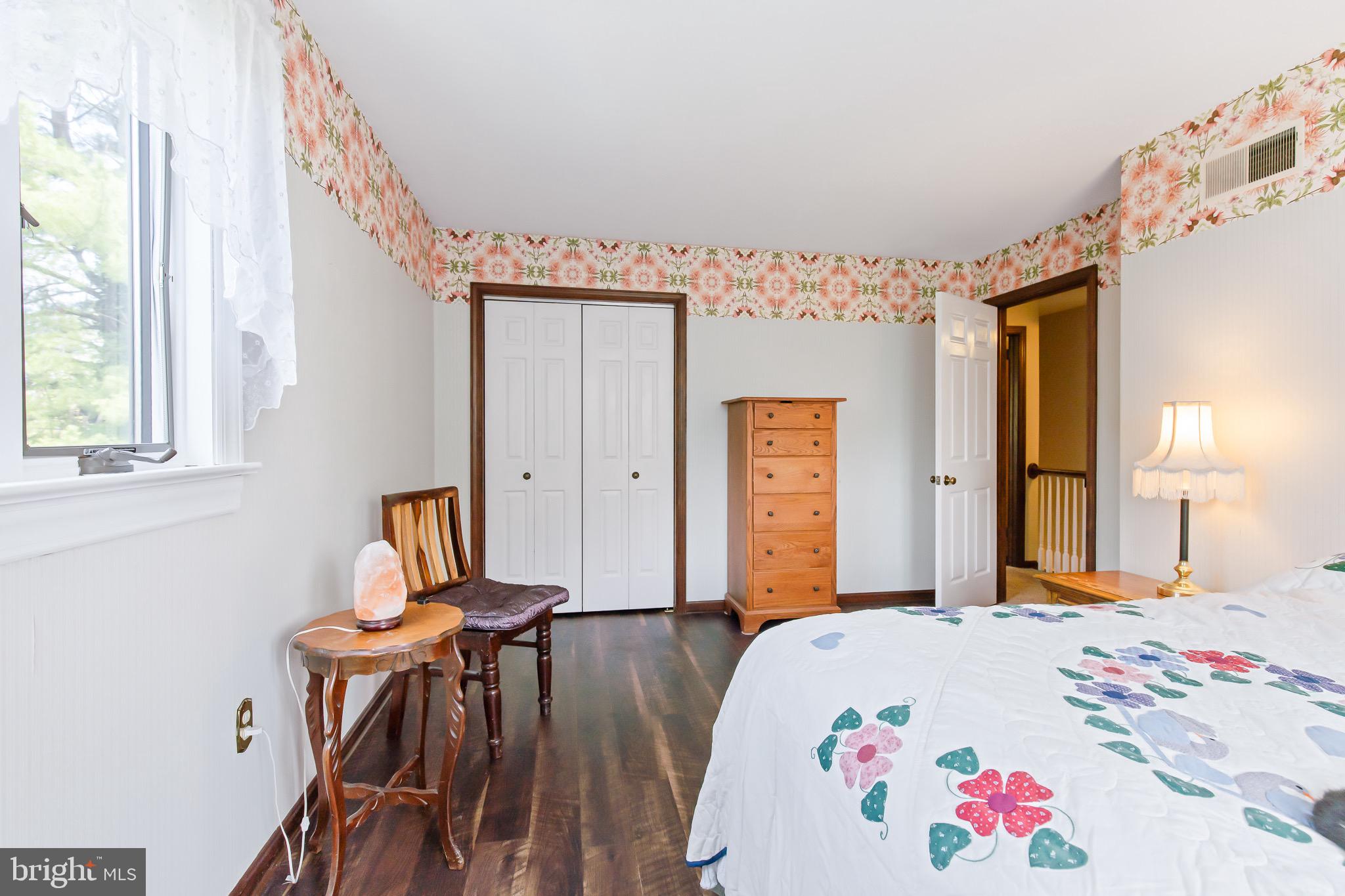 575 Millcross Road Lancaster, PA 17601 - Photo 30 of 47 a bedroom with a bed and a chandelier