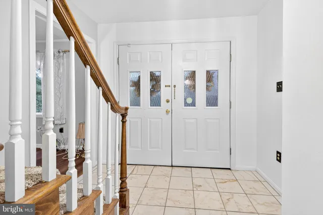 a dining room with a wooden table and chairs