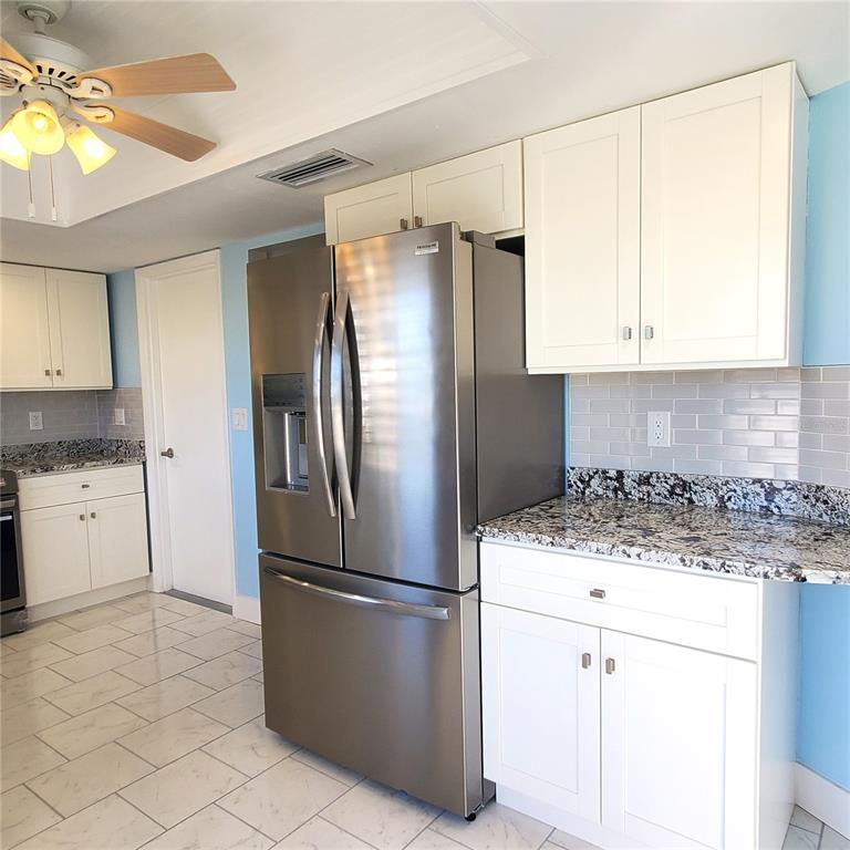 531 Neponsit Drive Venice, FL 34293 - Photo 12 of 37 a kitchen with a refrigerator a stove a sink and a window