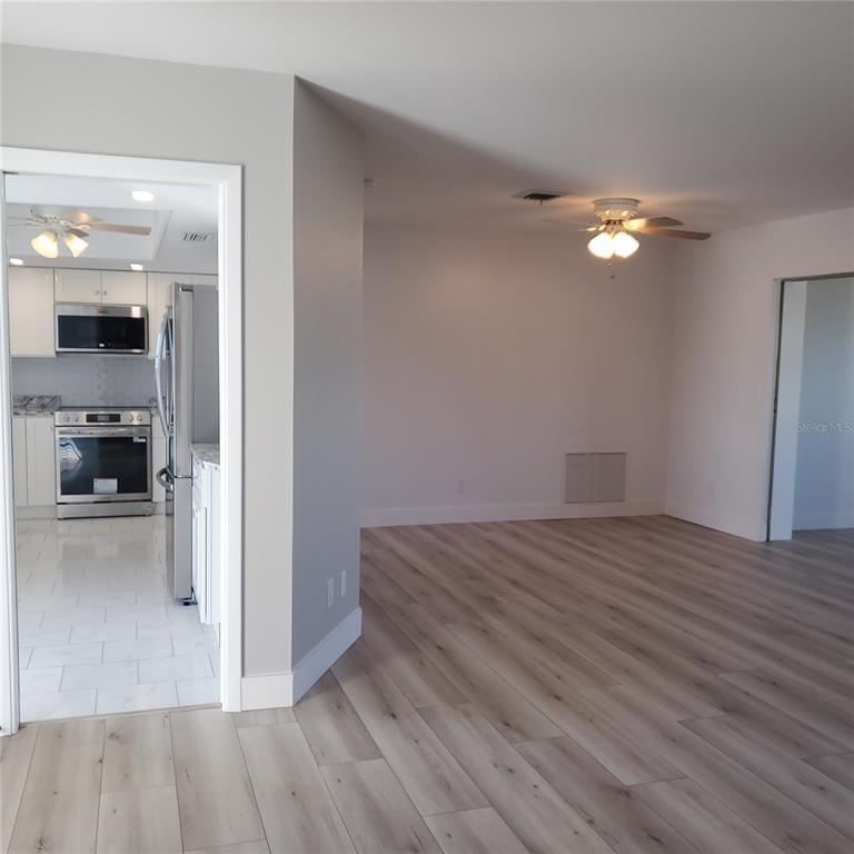 531 Neponsit Drive Venice, FL 34293 - Photo 14 of 37 a view of empty room with wooden floor