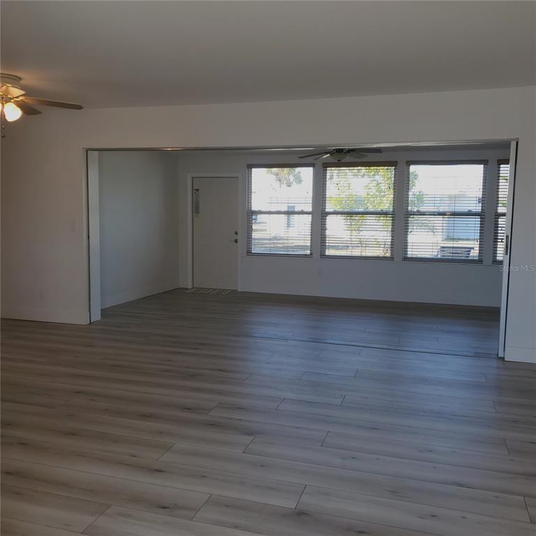 531 Neponsit Drive Venice, FL 34293 - Photo 18 of 37 wooden floor in an empty room with a window
