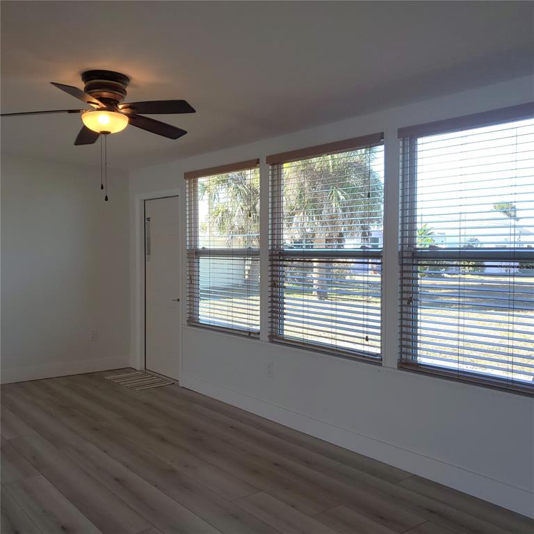 531 Neponsit Drive Venice, FL 34293 - Photo 19 of 37 a view of an empty room with wooden floor and a window