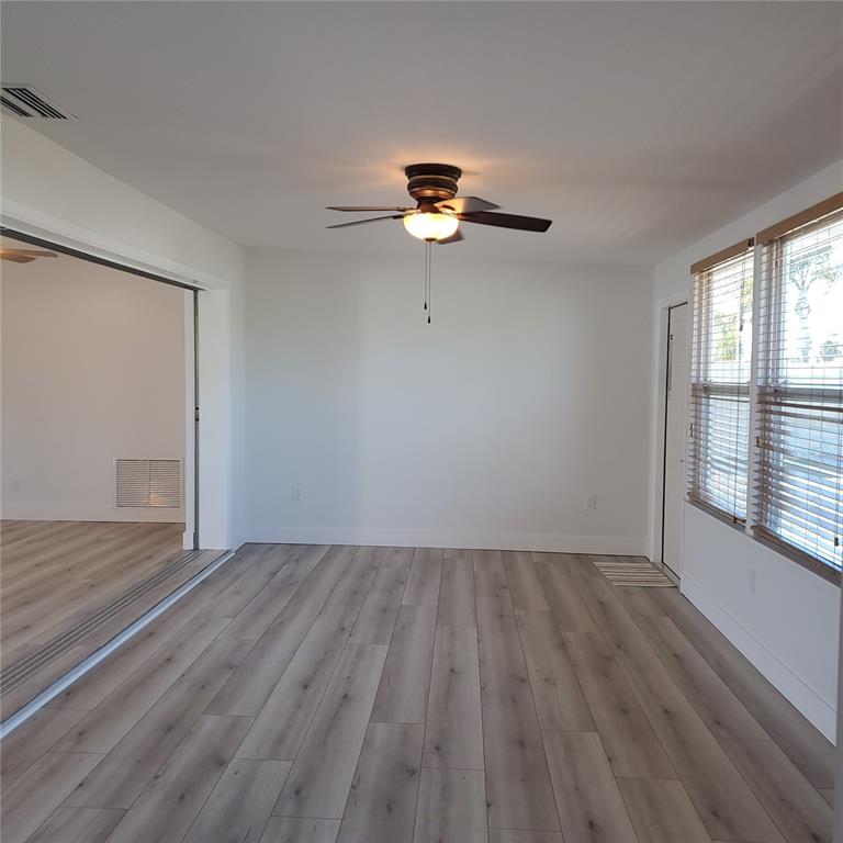 531 Neponsit Drive Venice, FL 34293 - Photo 20 of 37 a view of empty room with wooden floor and fan