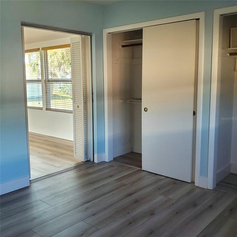 531 Neponsit Drive Venice, FL 34293 - Photo 21 of 37 an empty room with wooden floor closet and windows