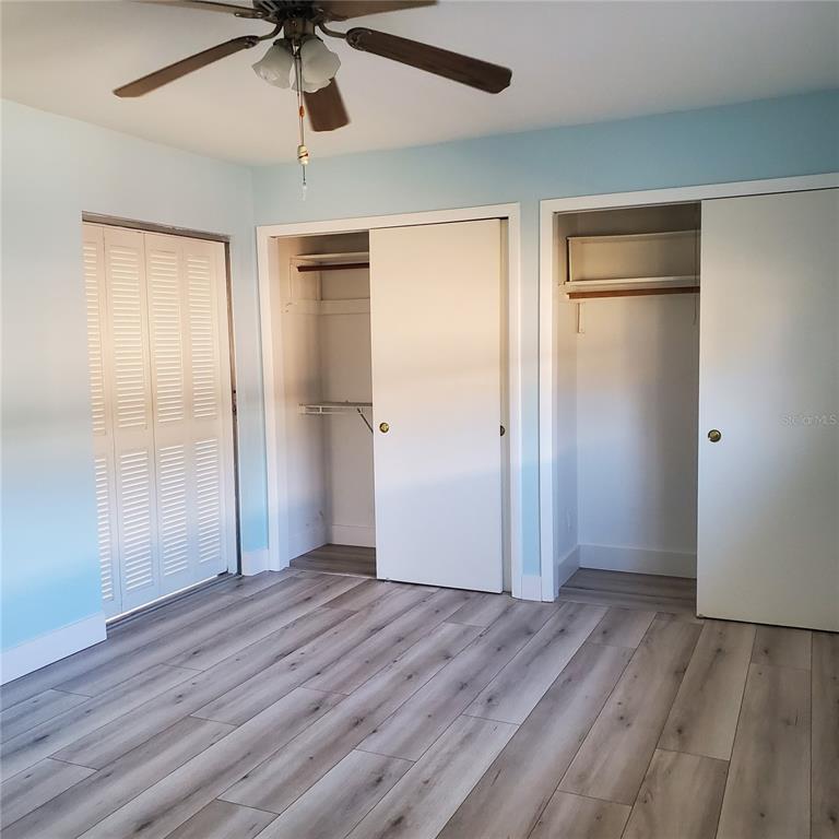 531 Neponsit Drive Venice, FL 34293 - Photo 22 of 37 an empty room with wooden floor closet and windows