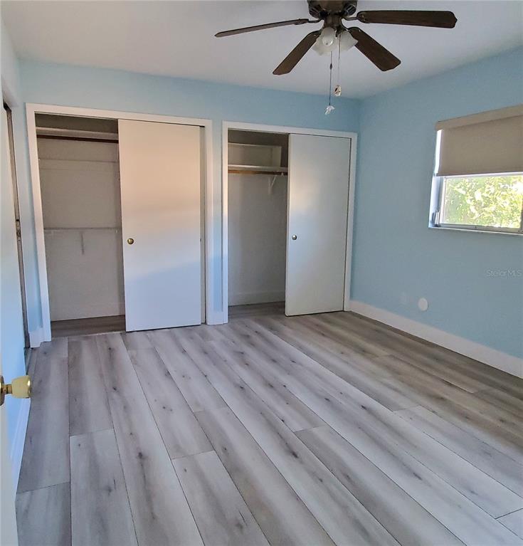 531 Neponsit Drive Venice, FL 34293 - Photo 23 of 37 a view of an empty room with wooden floor and a ceiling fan