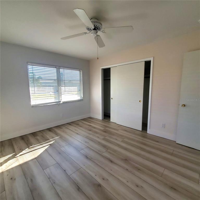 531 Neponsit Drive Venice, FL 34293 - Photo 27 of 37 a view of an empty room with wooden floor and a window