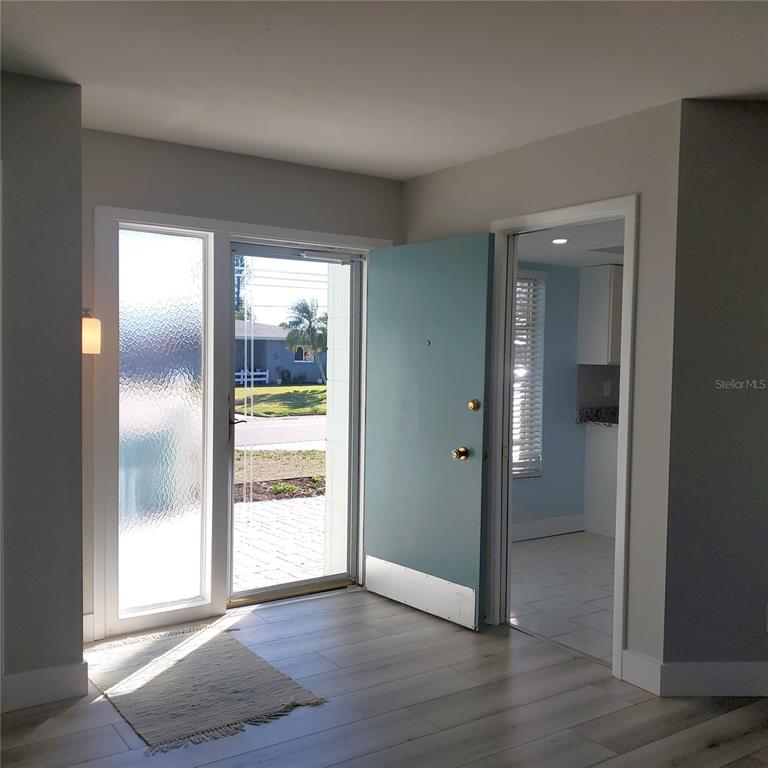 531 Neponsit Drive Venice, FL 34293 - Photo 7 of 37 an empty room with wooden floor and windows