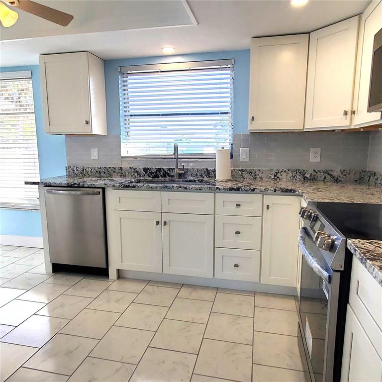 531 Neponsit Drive Venice, FL 34293 - Photo 9 of 37 a kitchen with a sink a stove and cabinets
