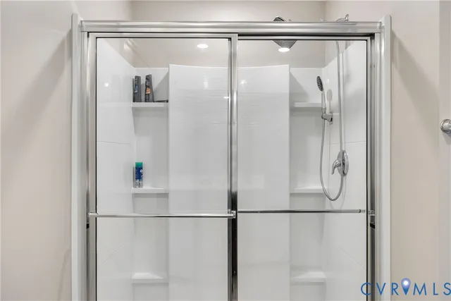 a bathroom with a glass shower door