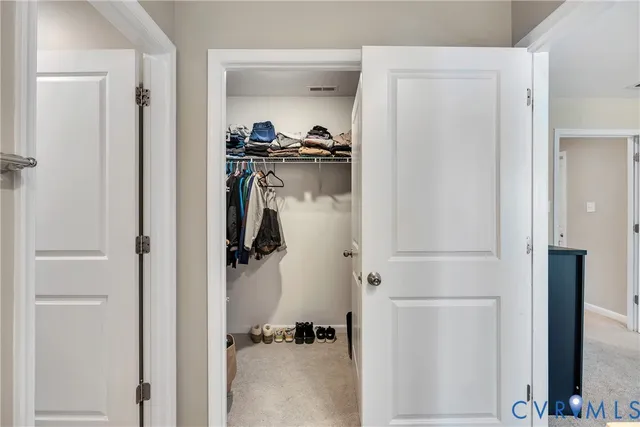 a walk in closet with a mirror