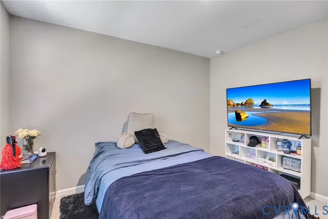 a bedroom with a bed and painting on the wall