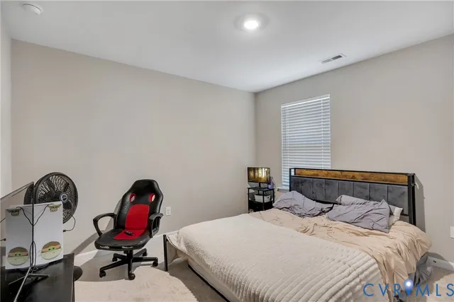 a bedroom with a bed a desk and chair